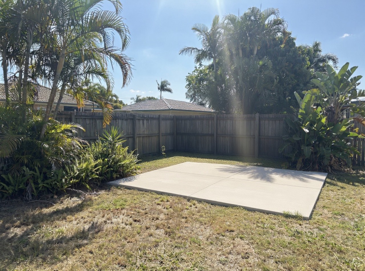 After: a clean, level concrete slab where the shed stood