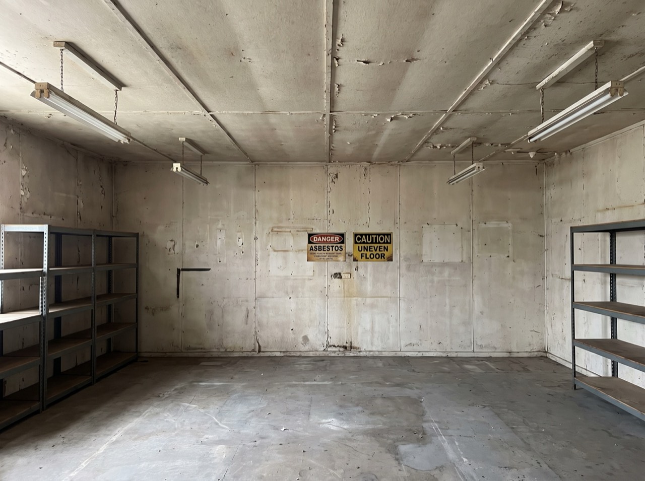 Before: a commercial interior with old fibro ceiling and wall sheeting