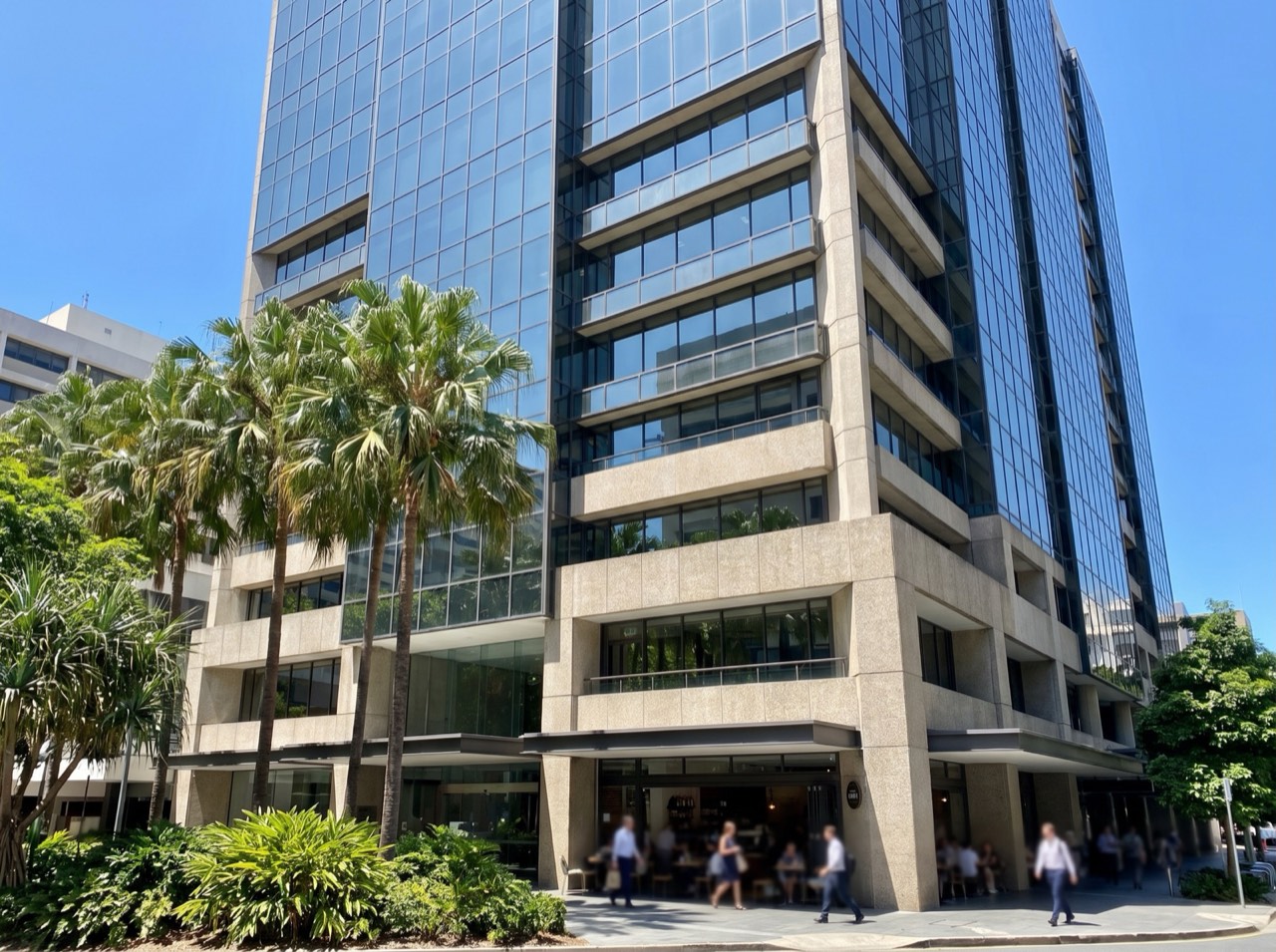 A generic Brisbane CBD commercial building exterior under a subtropical sky